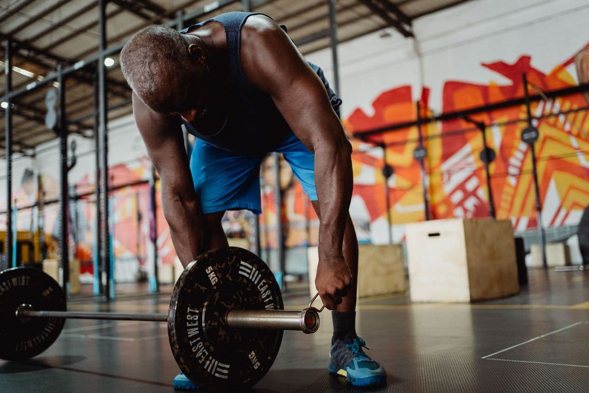 Member lifting a barbell during a strength training session