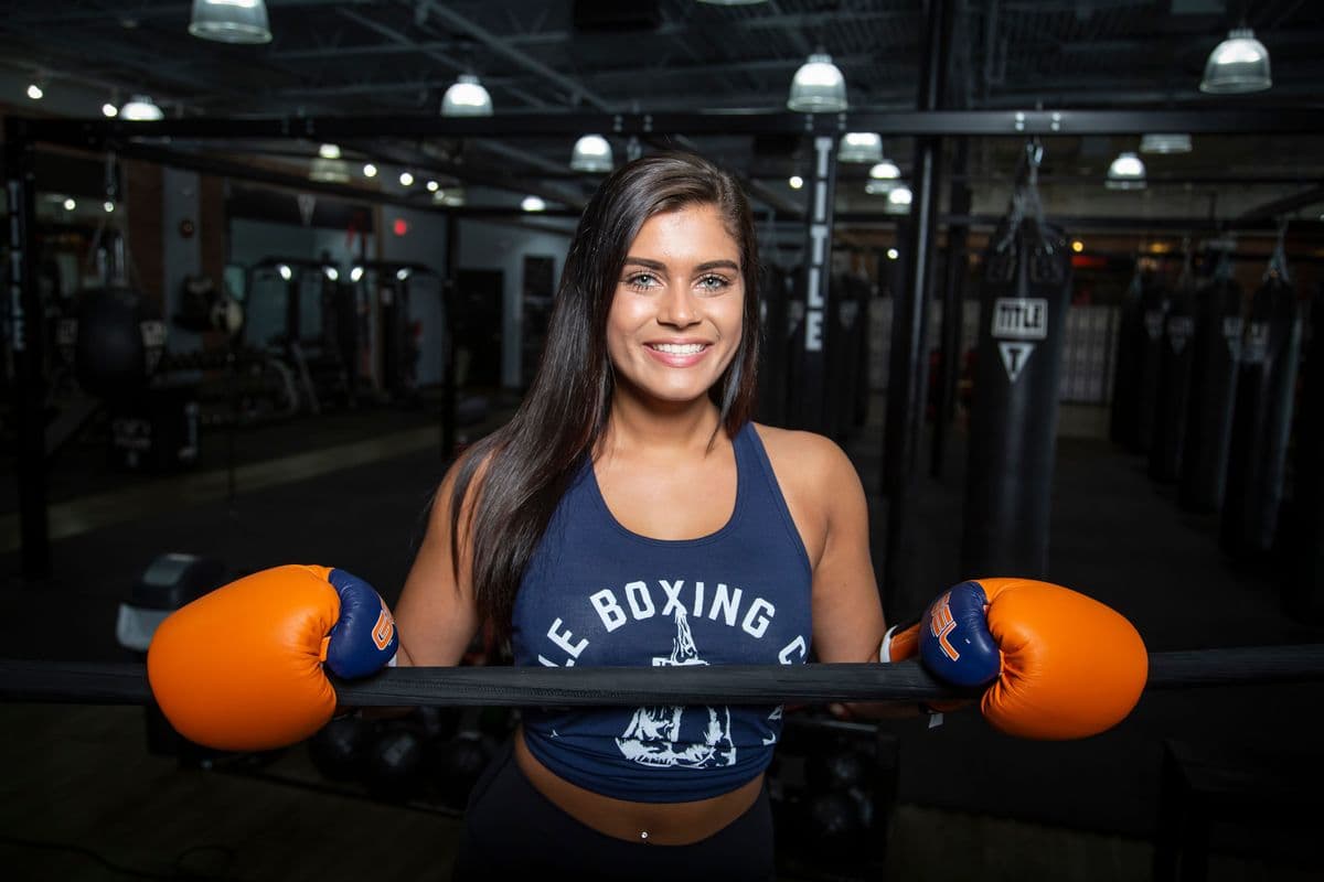 Member training with boxing gloves at Aarvi Gym